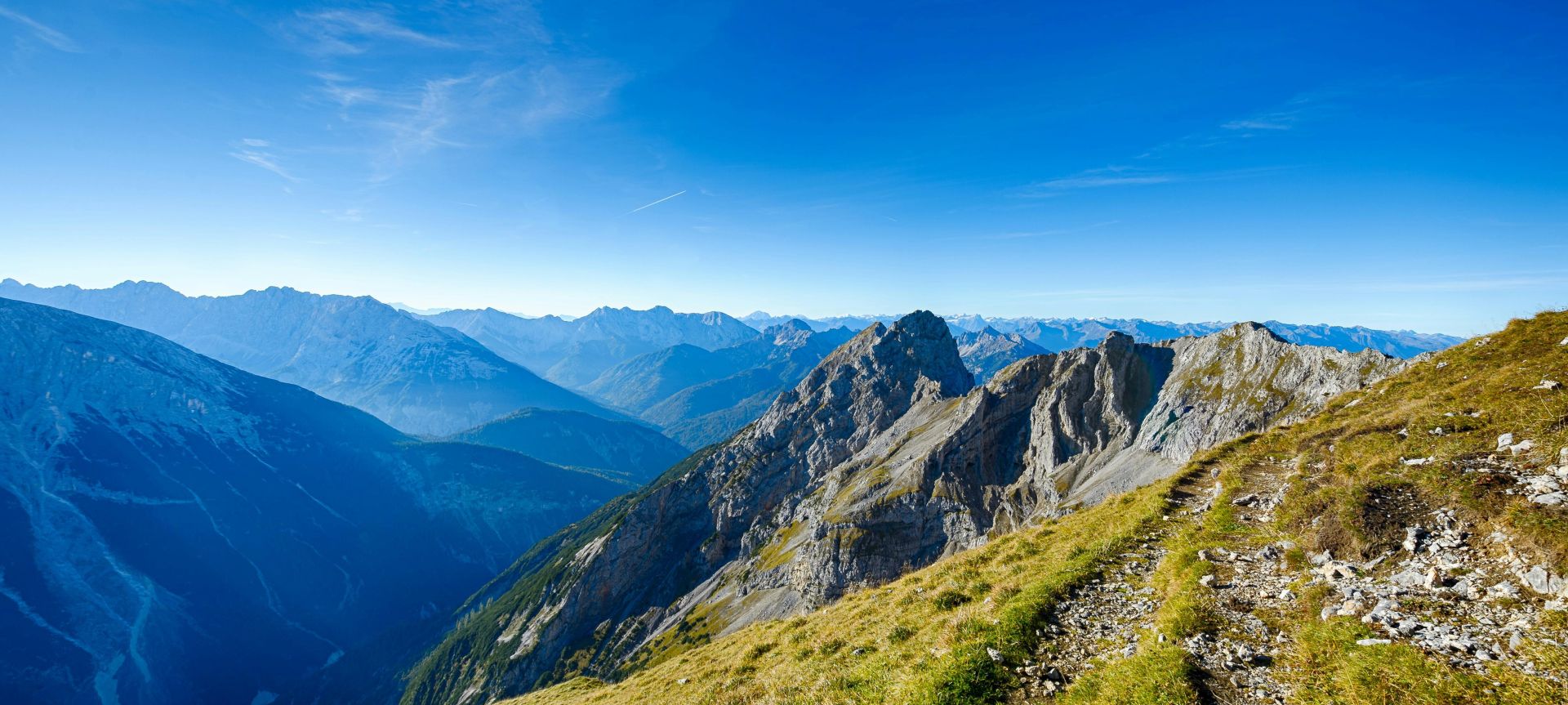 Stunning landscape of the rocky mountains with a vibrant blue sky in Mittenwald, Germany.